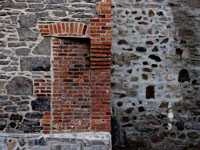 bricked doorway in vintage stone wall